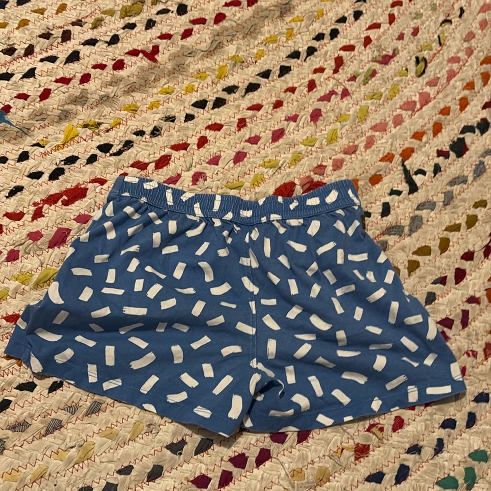 A pair of blue shorts for ages 9 to 12 with white sprinkles and brand 🫖 ❤️.
